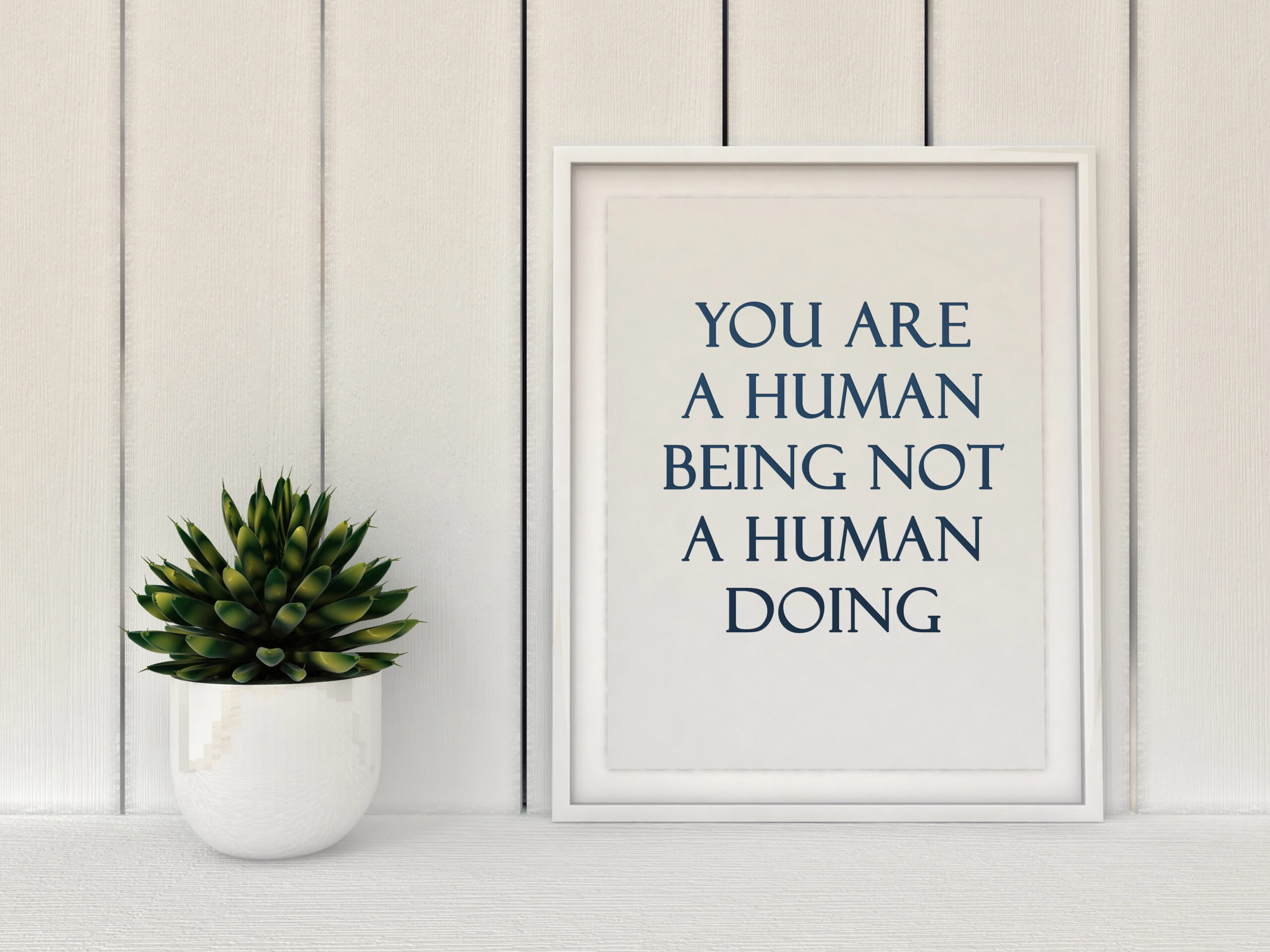 A sign that reads 'You are a human being, not a human doing,' emphasizing the importance of mindfulness and how to start living intentionally.