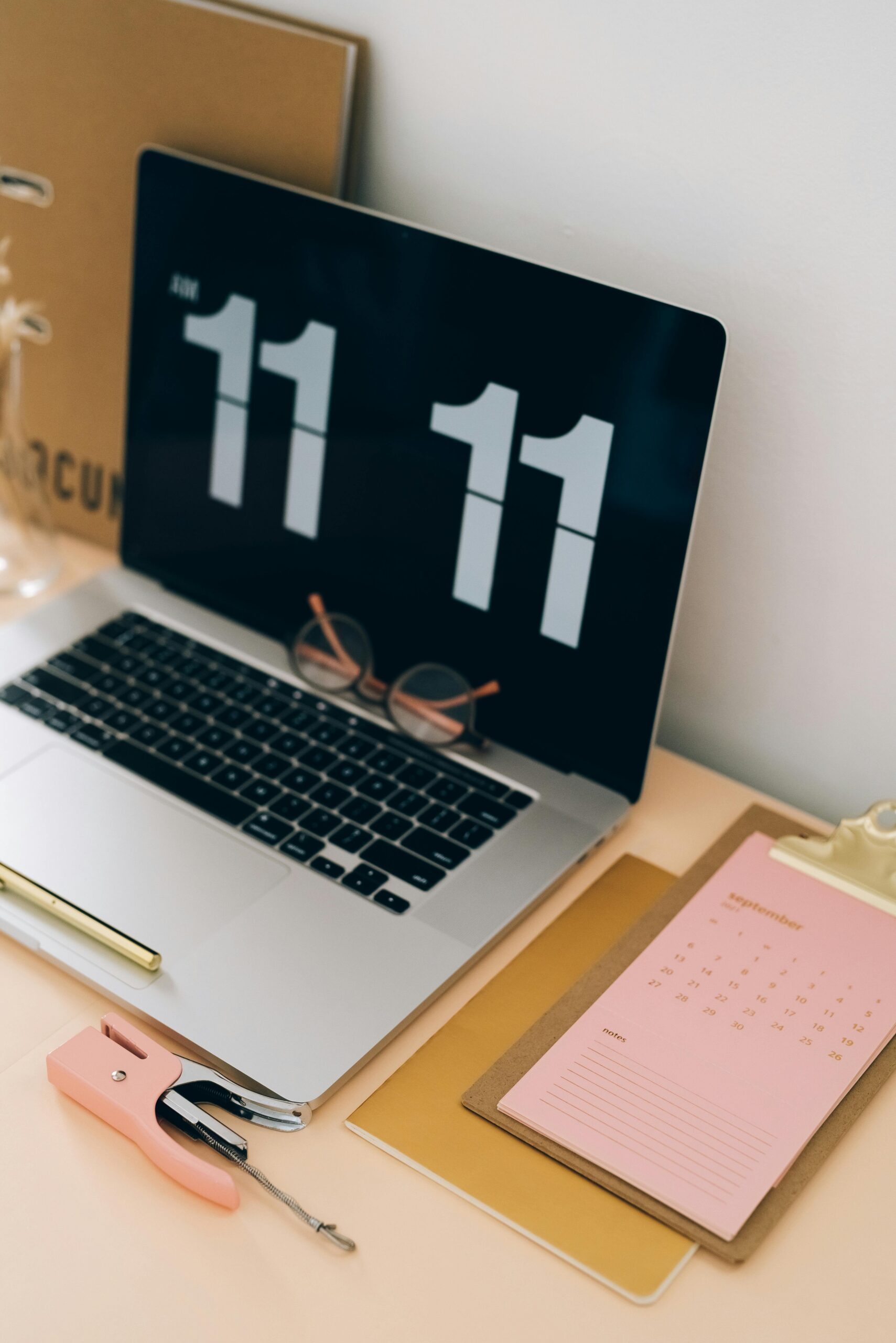 A desk with a computer displaying the time 11:11, symbolizing the significance of angel numbers as divine messages and signs of manifestation.