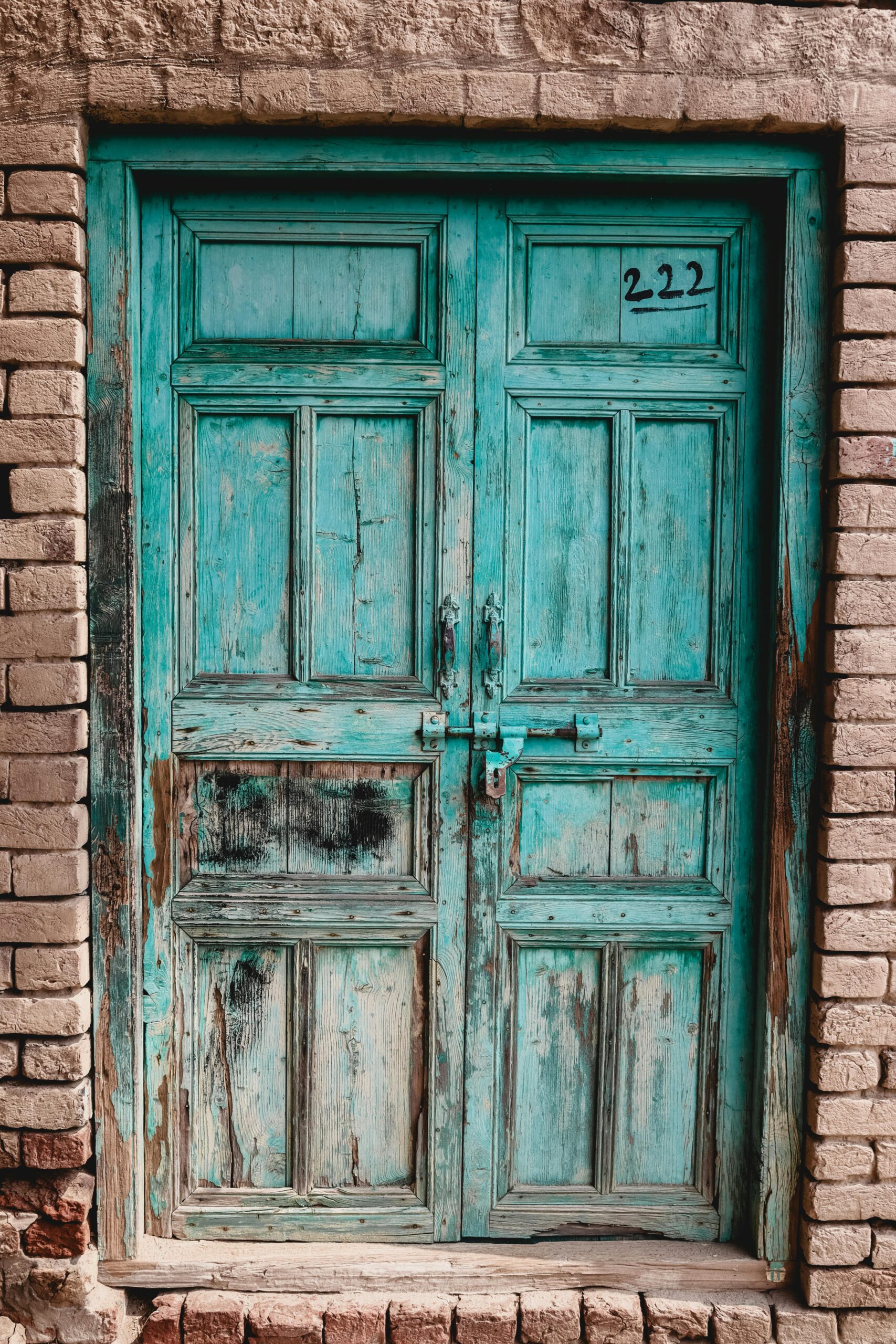 The number 222 displayed on a door, symbolizing angel numbers and the message of balance, trust, and alignment with divine timing.