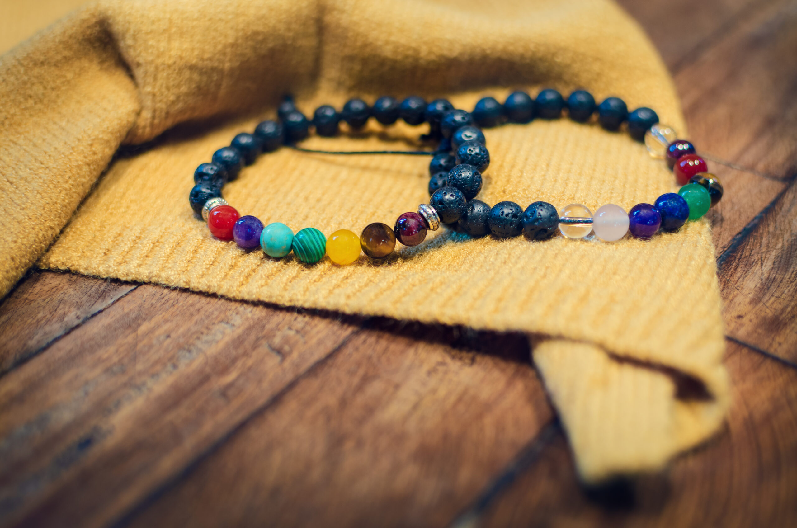 Two beautiful chakra bracelets with colorful beads representing the seven chakras, designed to balance energy and promote healing.