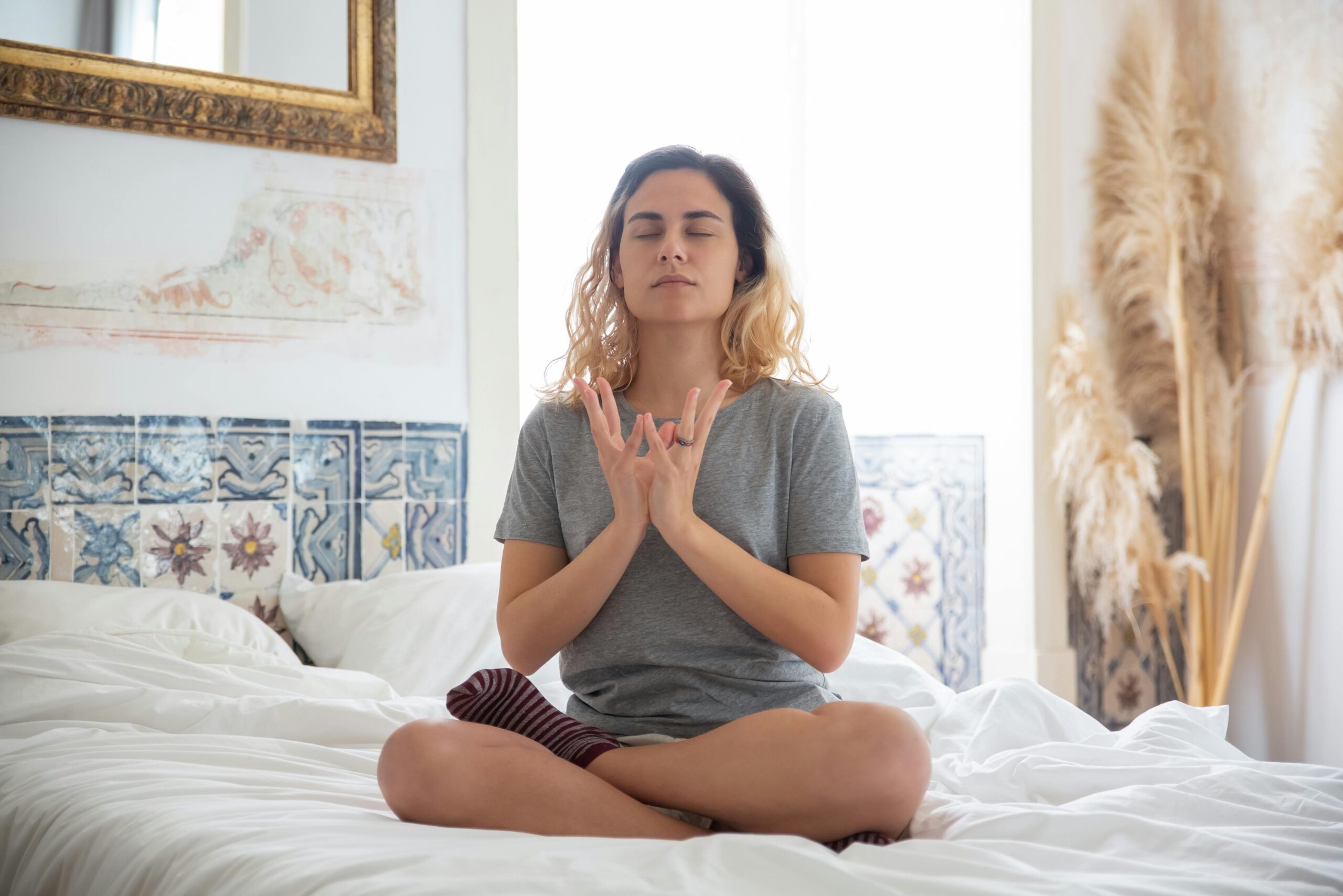 Woman meditating to clear manifestation mistakes and align energy for manifesting desires.