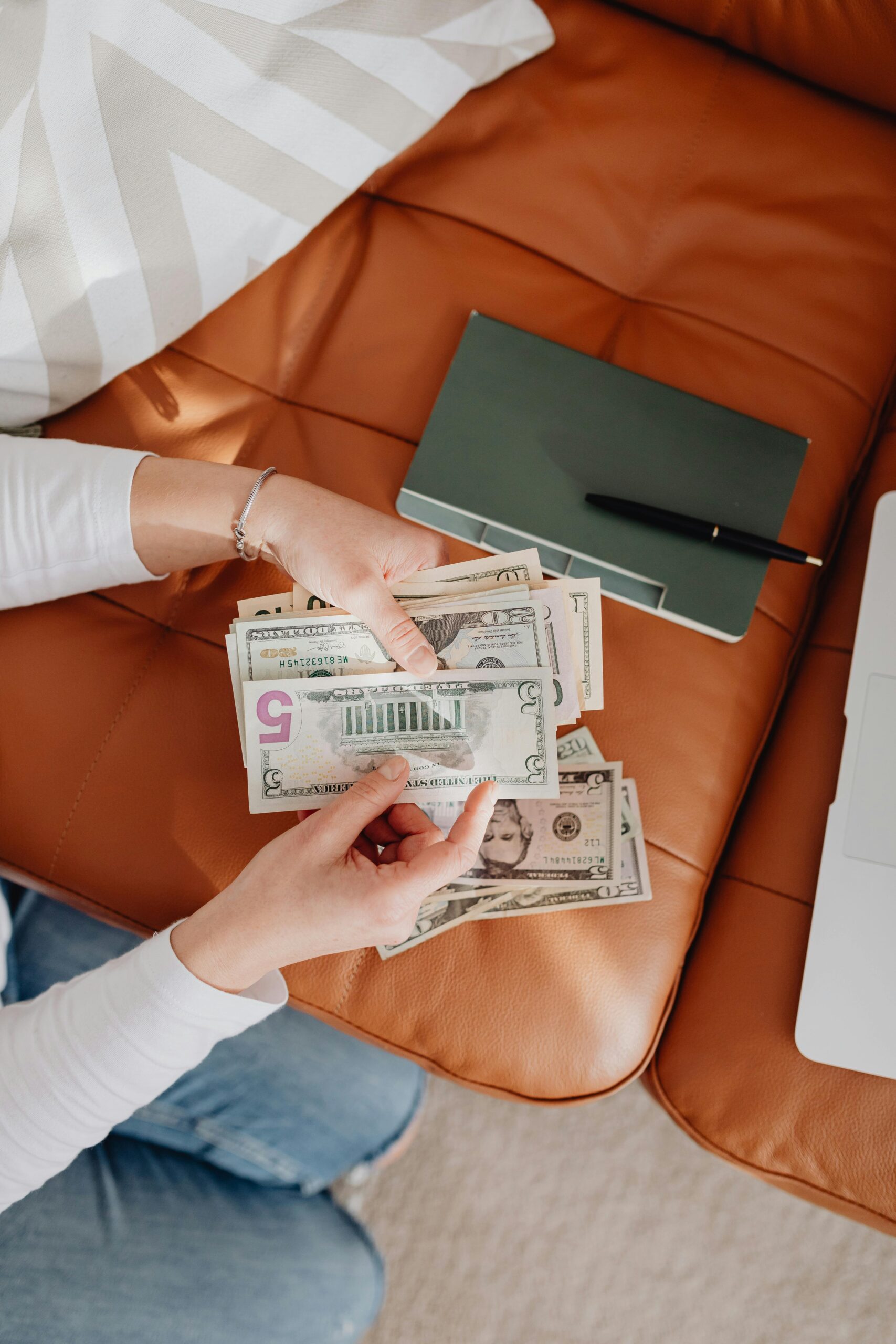 Woman holding a handful of cash, manifesting money overnight